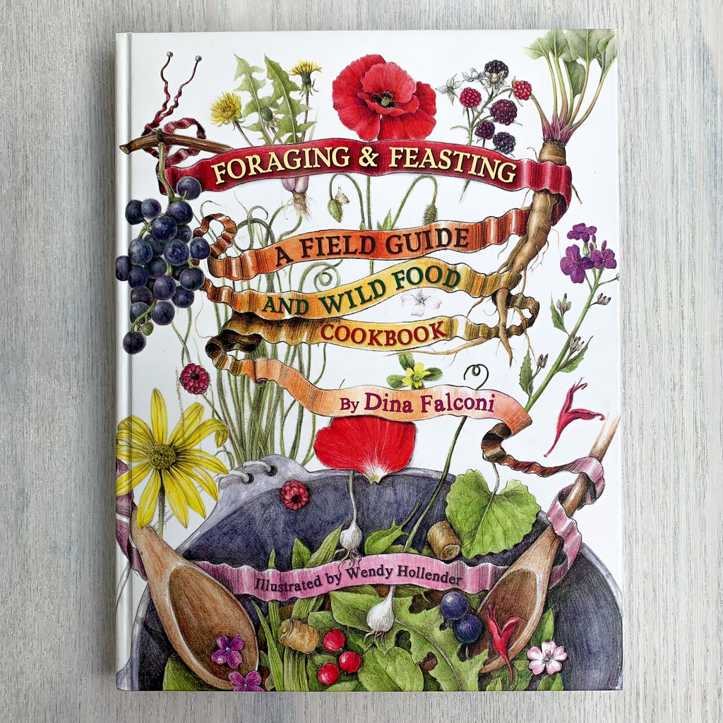White hardcover book featuring colorful botanical illustrations falling into a bowl and book title written on ribbon banners