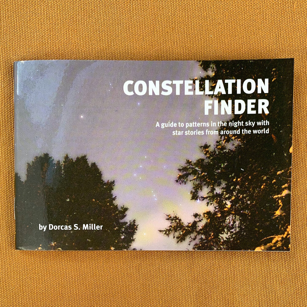 Pocket-sized softcover guide showing night sky behind tree silhouettes