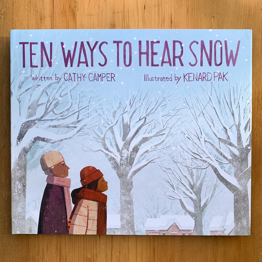 Hard front cover of Ten Ways to Hear Snow featuring an illustrated man and woman looking intent during a snowy walk through their tree-filled neighborhood.