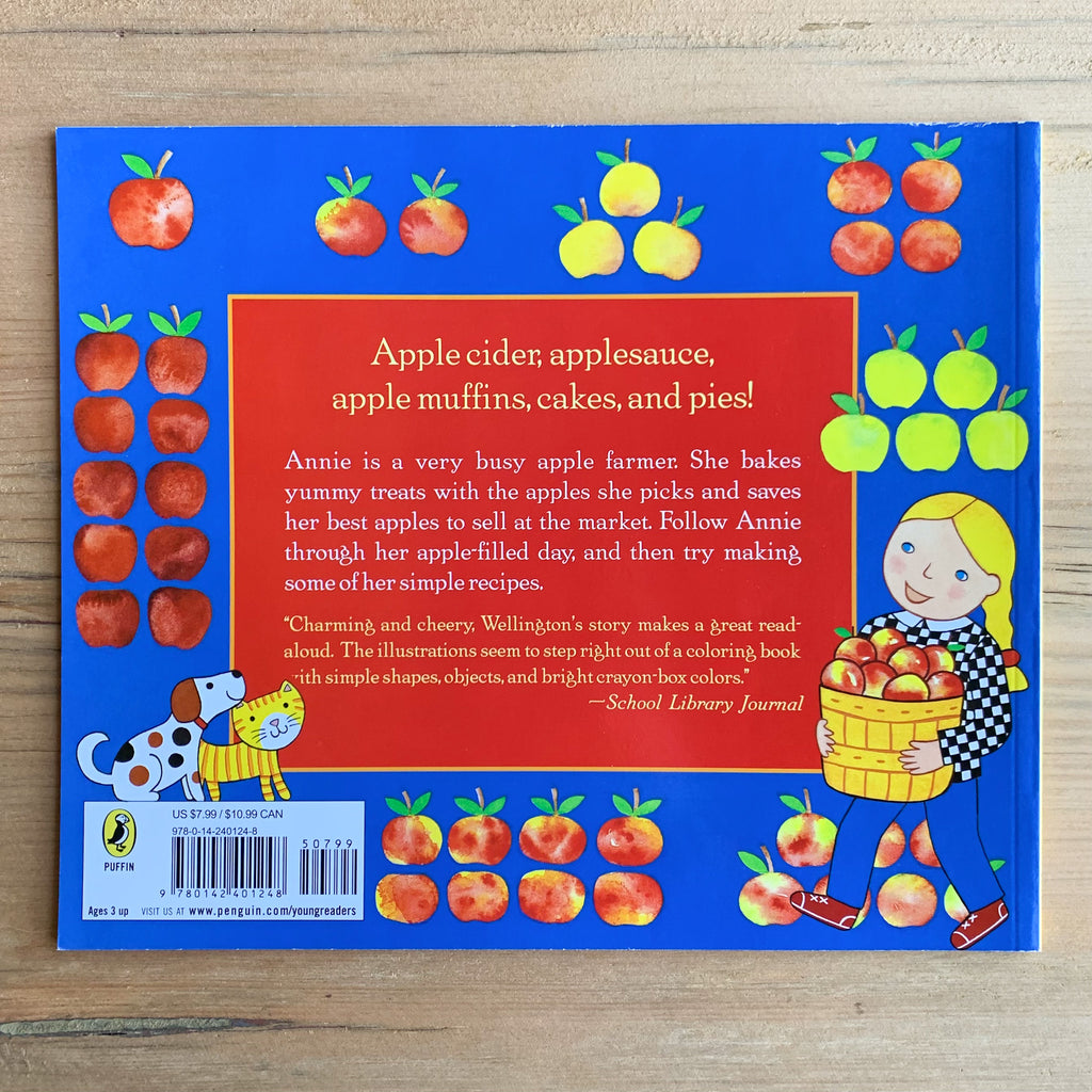 Back of picture book with blurb and illustration of Annie, her cat and dog, and various apples