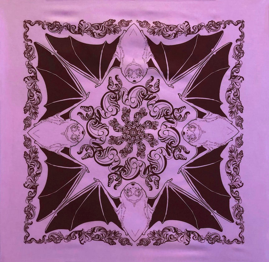 Violet bandana with a dark purple print of four bats facing one another on each side with wings extended creating a star shape with swirling patterns in the middle.