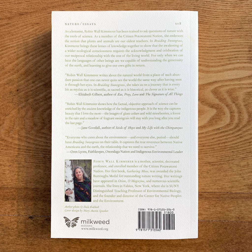 Back book cover, cream with green text blurbs and photo of gray-haired author