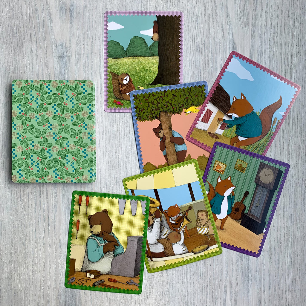 Splay of large-format cards with different scenes featuring animal protagonists