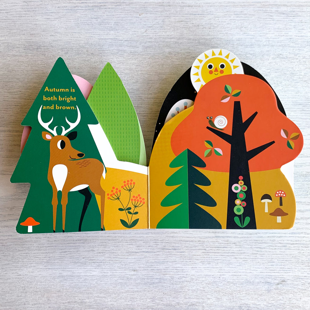 Interior pages of colorful, die-cut board book featuring trees, deer, and mushrooms