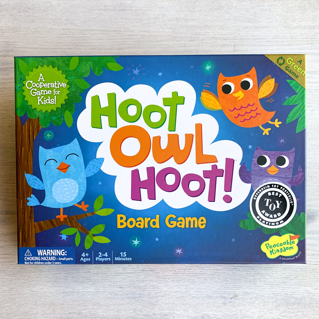Blue board game box featuring colorful cartoon owls in a night sky
