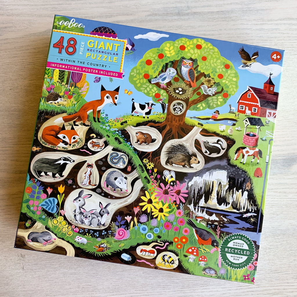 Within the Country Puzzle front box cover featuring illustrations of cute animals in their burrows and nests.