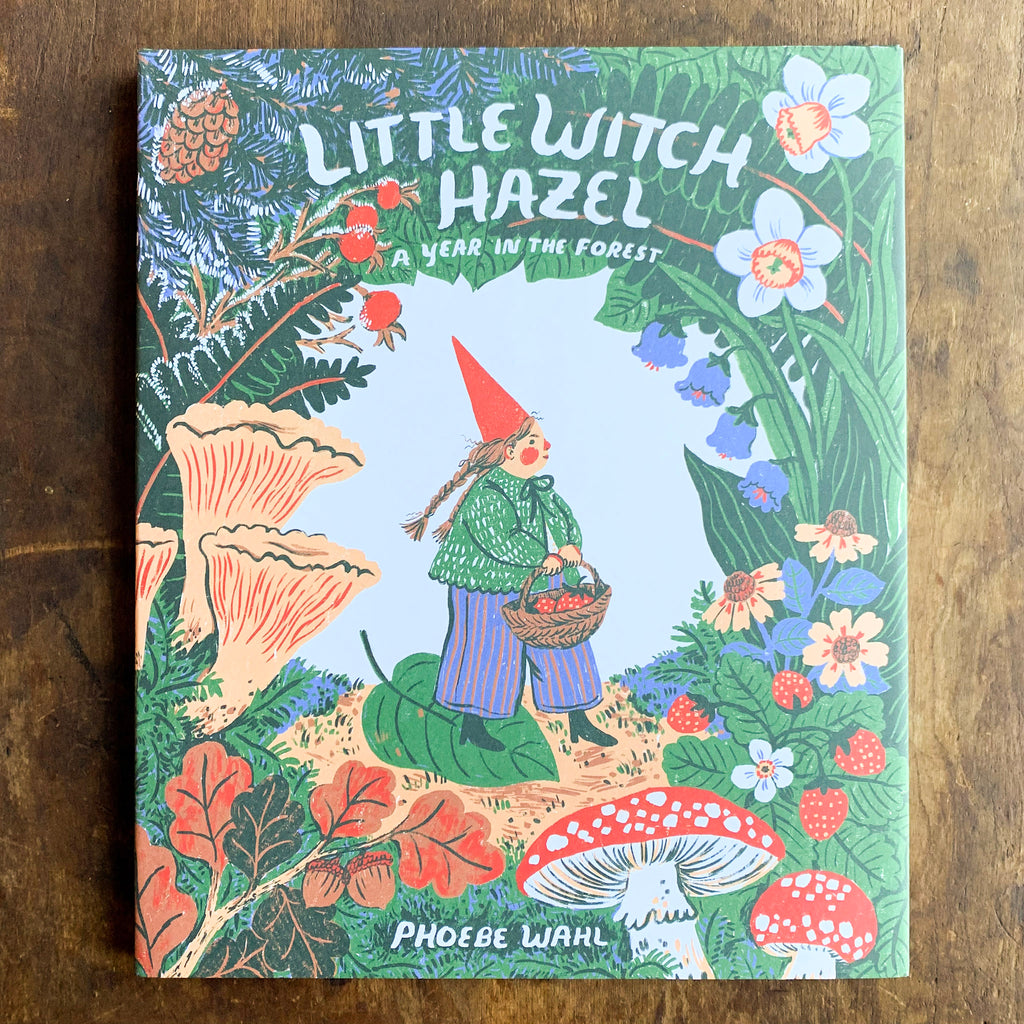 Front hard cover of Little Witch Hazel showing the Little Witch Hazel character foraging surrounded by flowers and mushrooms and trees.