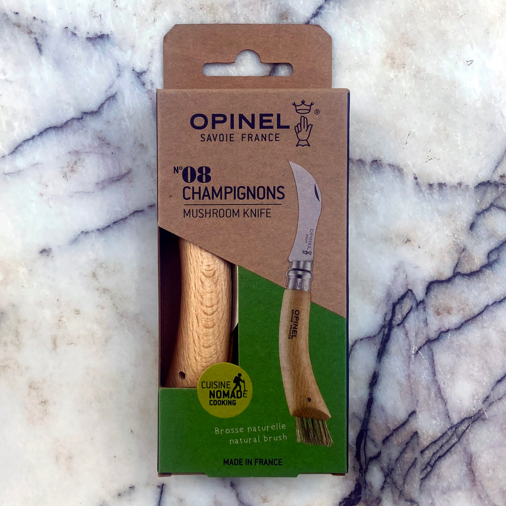 Opinel No. 08 Mushroom Knife shown in original packaging with oak handle showing through box.