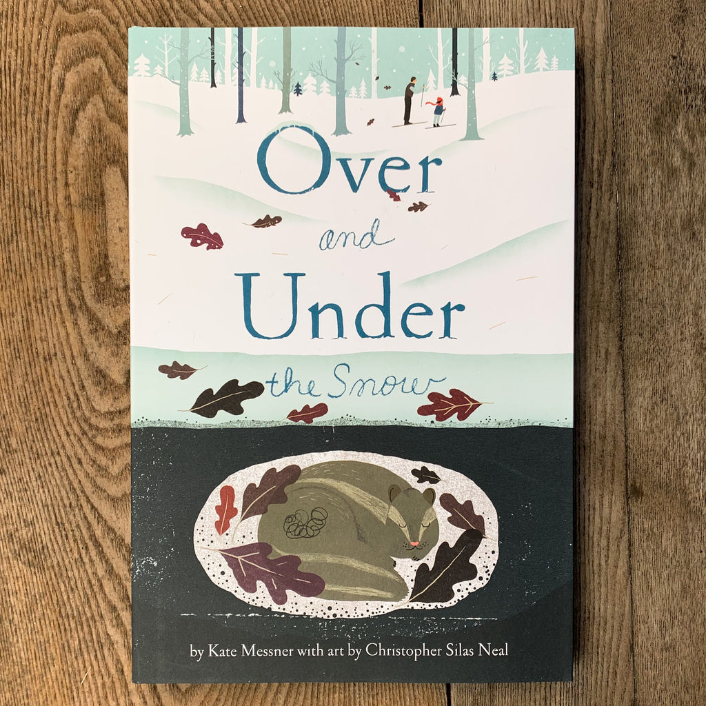 Front cover of Over And Under The Snow featuring parent and kid cross country skiing through a snowy woods and a hibernating critter cozily dozing beneath the surface.