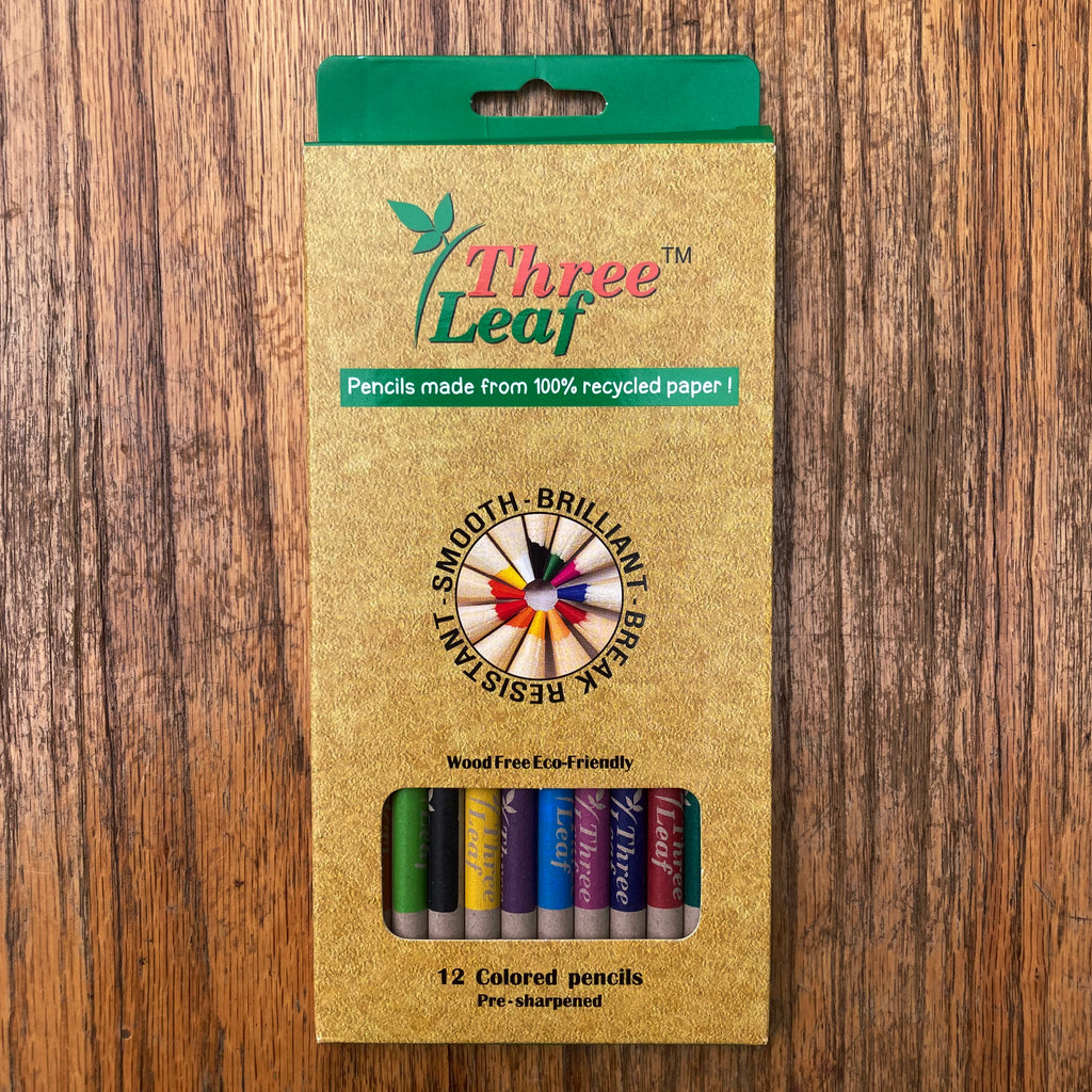 Front of Three Leaf colored pencil packaging stating product is made from 100% recycled paper. A small window shows colors of the pencils contained within.