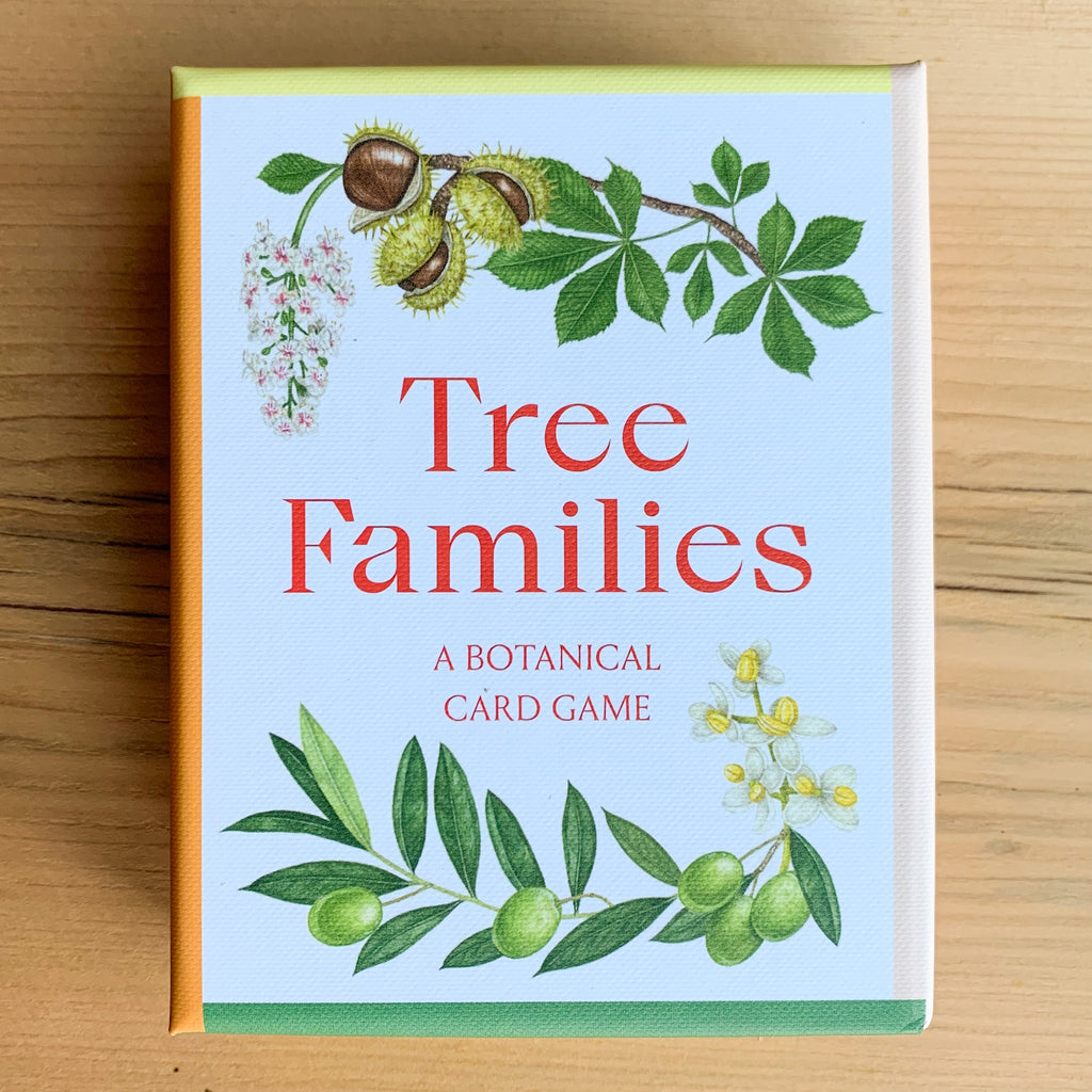Front cover of Tree Families card game box with illustrations of plants with their leaves, flowers, and fruit against a pale blue background.