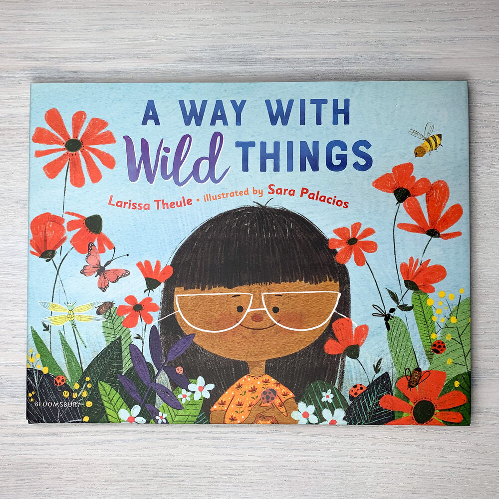 Hardcover picture book cover. Illustration of child with brown skin, white half-moon glasses, and black bangs in a field of red poppies surrounded by bugs