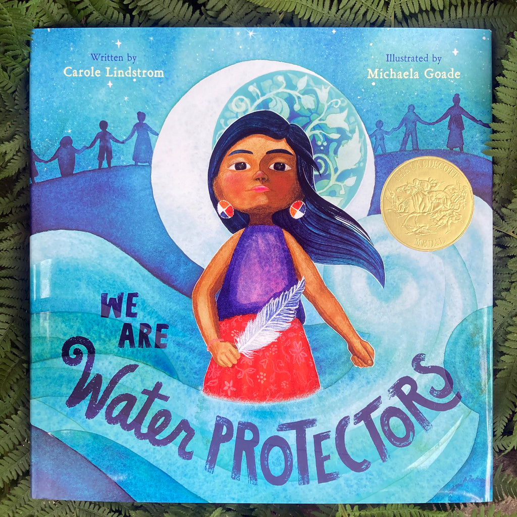 Front cover of We Are The Water Protectors dust jacket displaying a stylized illustration of an indigenous girl standing before the moon and holding a feather before the silhouettes of people holding hands in the background.