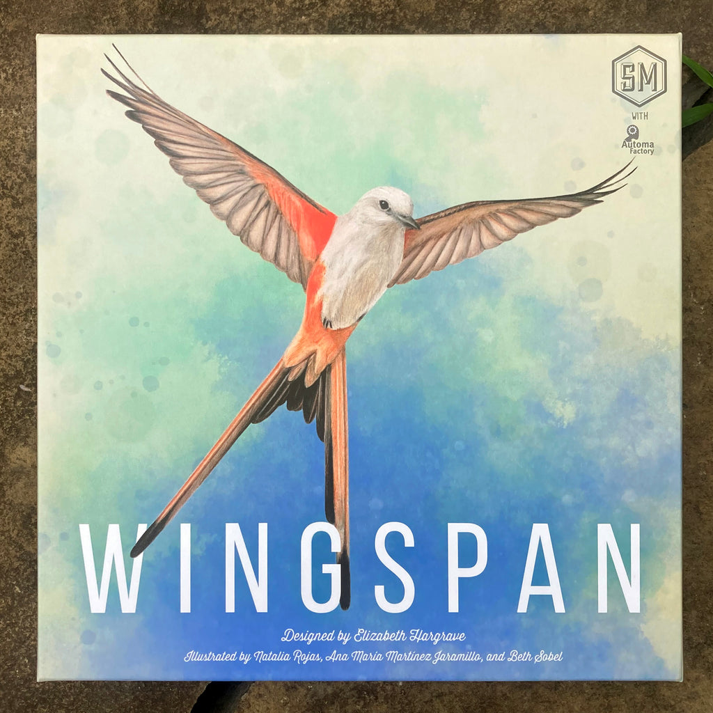 Front cover of WINGSPAN game box featuring a lifelike illustration of a scissor-tailed flycatcher in midflight with wings and tail feathers extended.