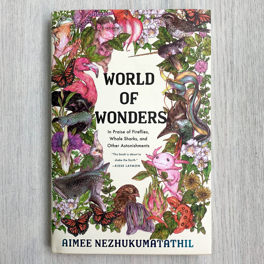 Hard front cover of World of Wonders featuring lifelike illustrations of many animals and plants.